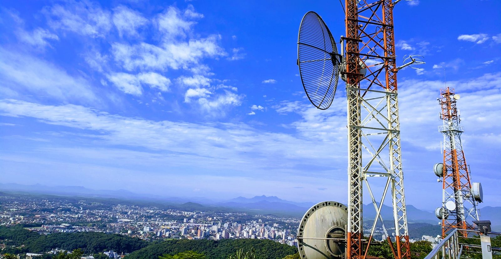 red and white metal tower under blue sky during daytime